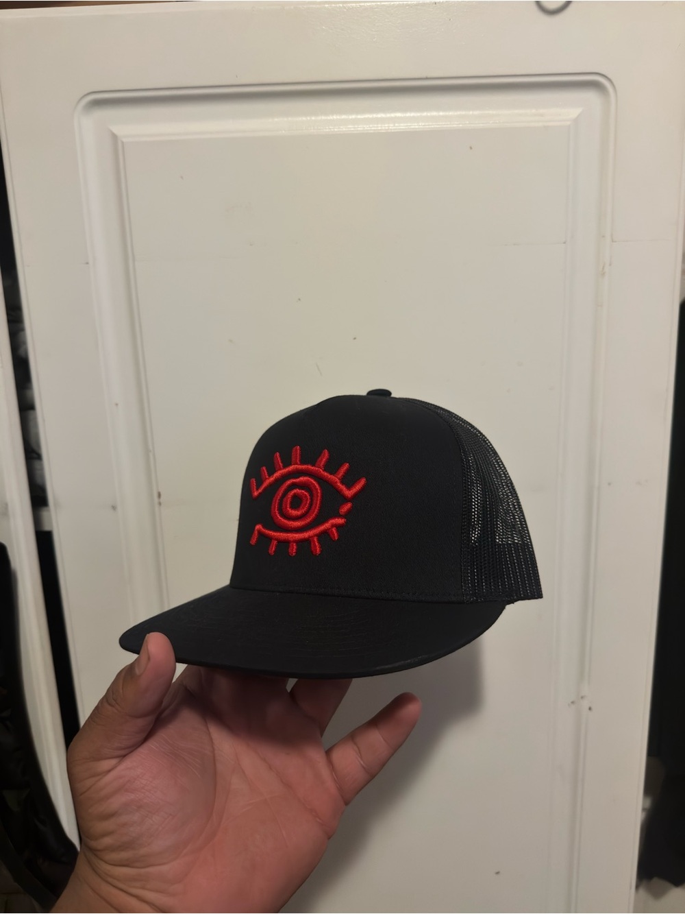 Black Snapback Trucker Hat with Red Eye Embroidery